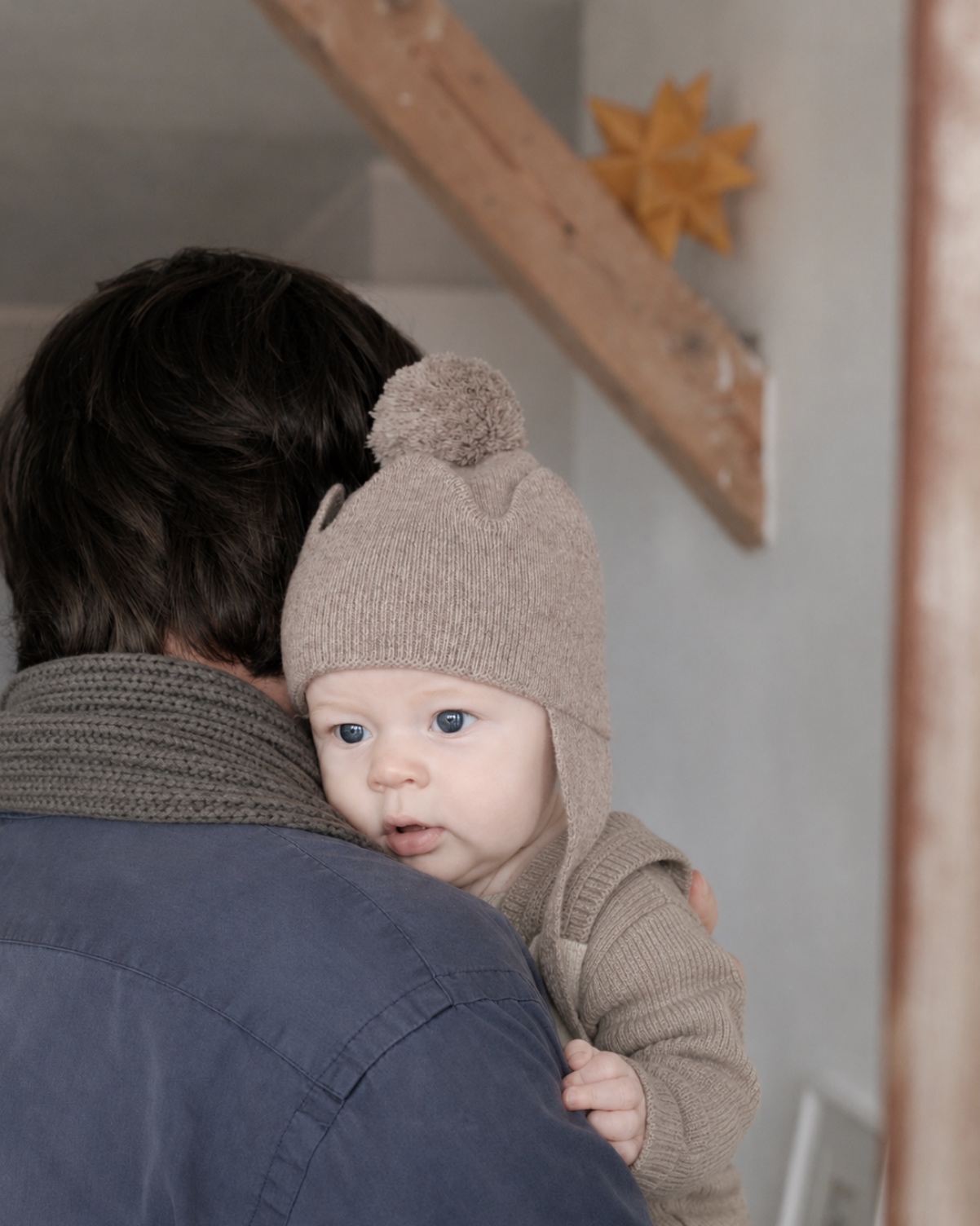 Baby wearing the soft Crown beanie while being held by a parent